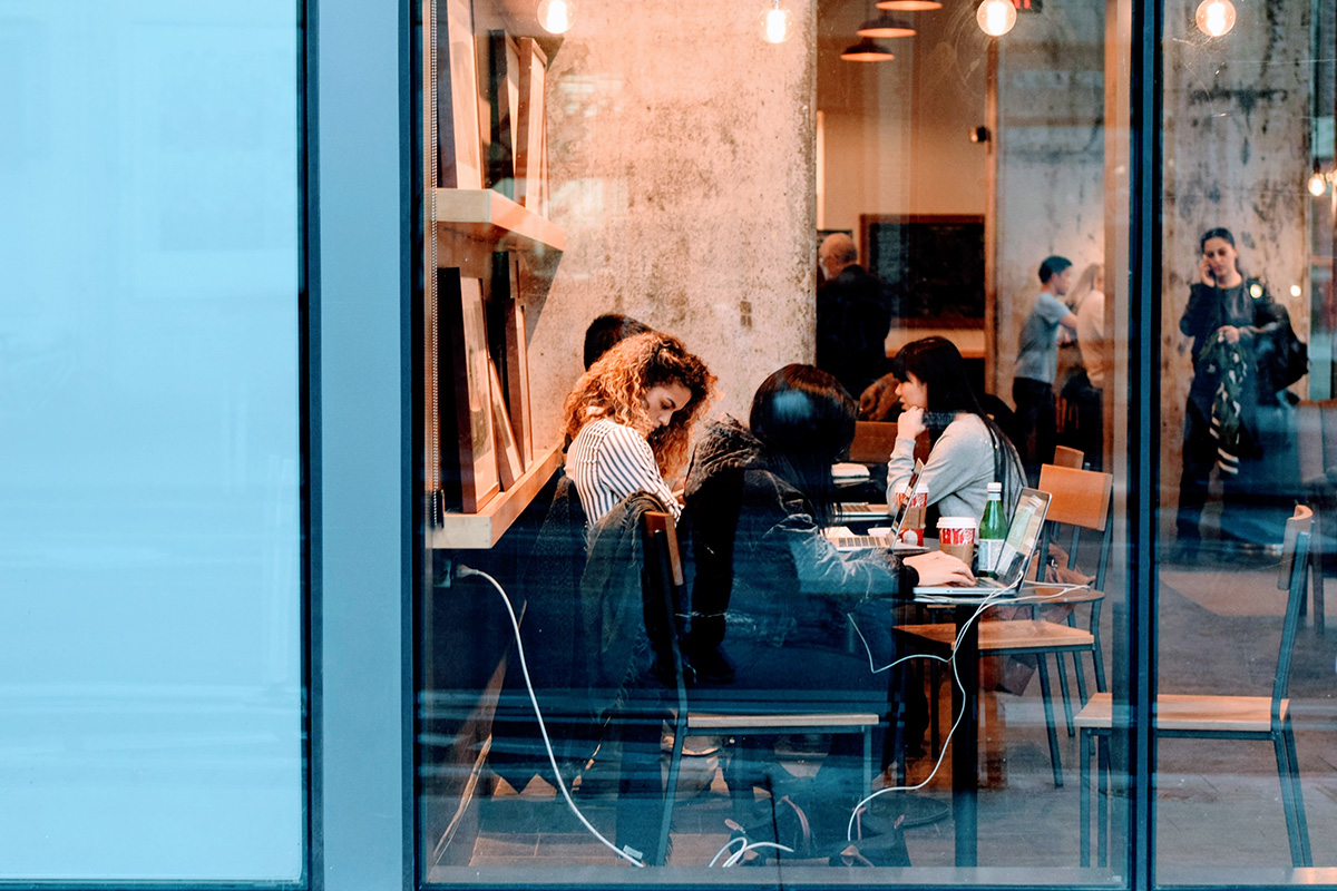 A group of individuals, busy in a coffee shop